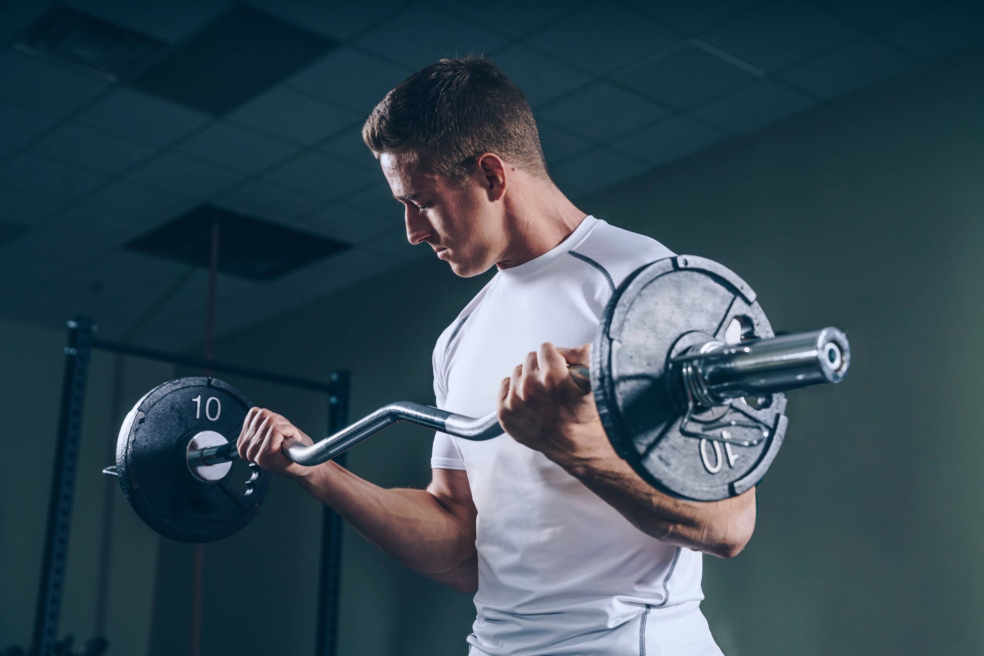 Man lifting a barbell in a gym setting